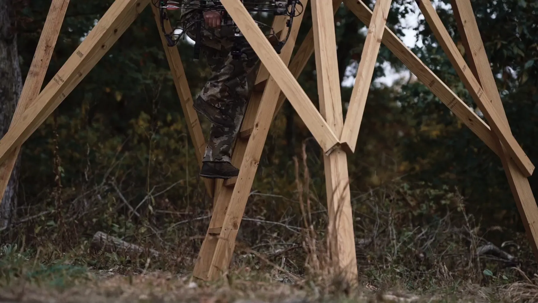 A hunter climbing the ladder into a finished blind.